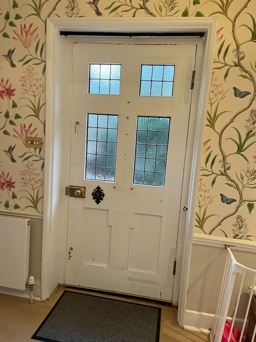 Hand-hung designer wallpaper in a country house entrance hall